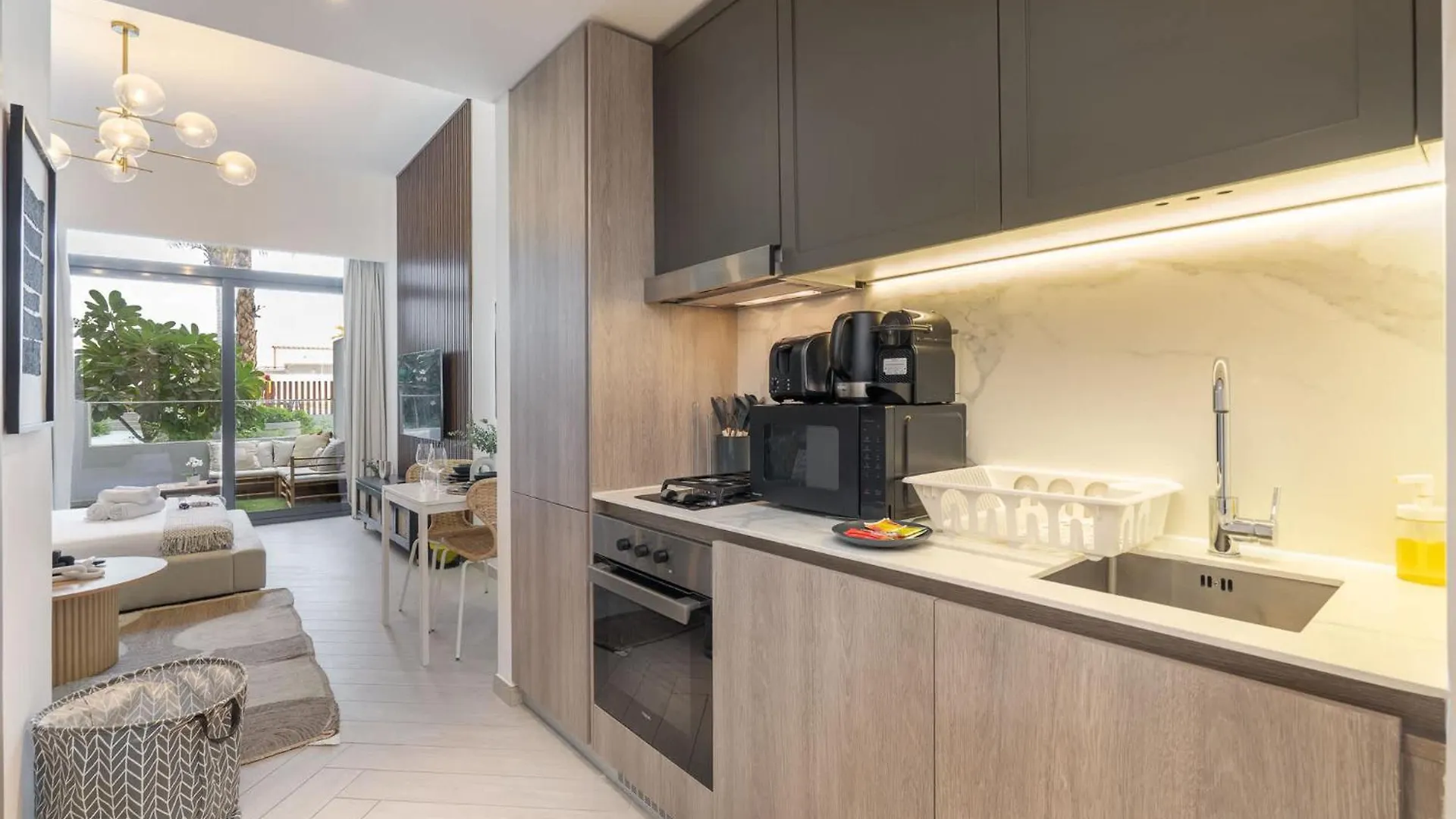 Minimalist Studio With Nature-Inspired Balcony In Jvc Dubai Apartment